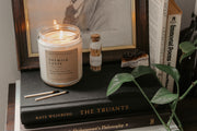 Perfect for book lovers, our Grace + Bloom literary candles are hand-crafted in our sunny shop from natural soy wax with cotton wicks for a clean burn experience, while their modern and minimalist design adds a special touch to any home. With warm, book-inspired scents and a cozy glow, you can create the perfect ambiance for unwinding and curling up with a good book! They also make a thoughtful and sophisticated gift idea for your favorite bookworm.  Light it up for a cozy evening of reading!