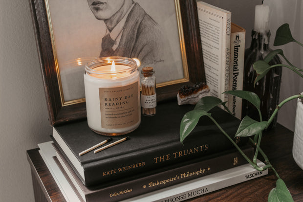 Perfect for book lovers, our Grace + Bloom literary candles are hand-crafted in our sunny shop from natural soy wax with cotton wicks for a clean burn experience, while their modern and minimalist design adds a special touch to any home. With warm, book-inspired scents and a cozy glow, you can create the perfect ambiance for unwinding and curling up with a good book! They also make a thoughtful and sophisticated gift idea for your favorite bookworm.  Light it up for a cozy evening of reading!