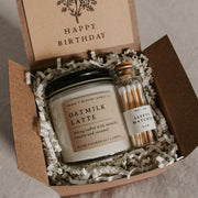 Give the gift of coziness with a boxed birthday gift from Grace and Bloom Co! It includes a small candle in a literary book inspired scent and a glass cork-topped bottle of matches. A card that says Happy Birthday in a vintage botanical style is attached to the inside cover of the box. It can be removed and used as a bookmark.