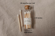 Our pretty glass bottles with cork lids come in the dark academia gift box with 20 safety matches. This picture shows their measurement of 2.75" x .86".