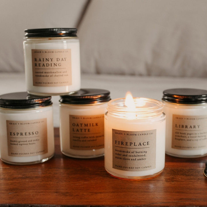 Collection of Corduroy Lane candles with labels on a wooden surface